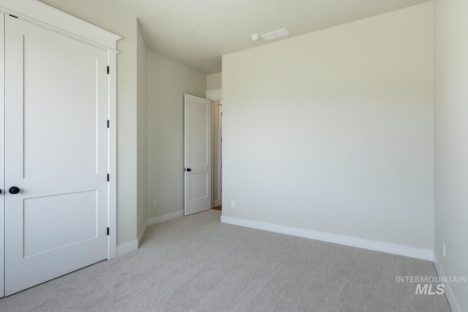 5054 Heritage Drive Marsing, ID 83639 - Photo 25 of 38 Neutral-toned wall paint with coordinating light carpet flooring