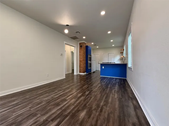 a view of kitchen and hall with wooden floor