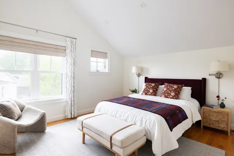 a bedroom with a bed and a couch