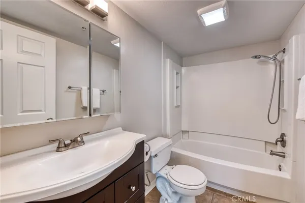 a bathroom with a sink toilet tub and shower