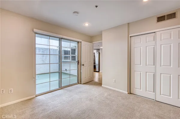 an empty room with a cabinet and mirrors