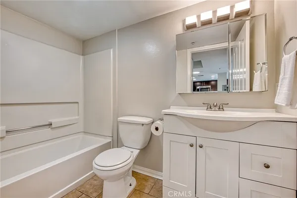 a bathroom with a sink toilet vanity and tub