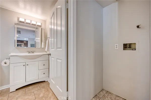 a bathroom with a sink a mirror and a shower