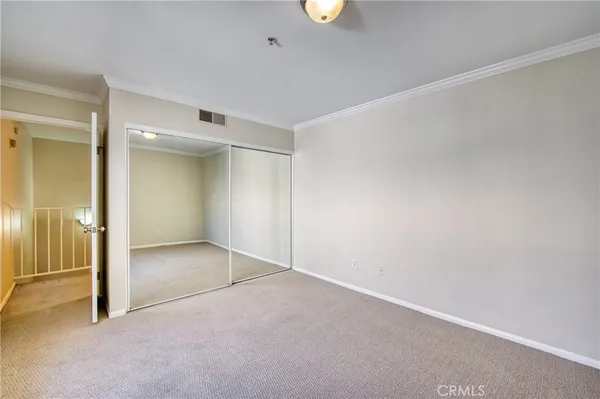 an empty room with a bench and a cabinet