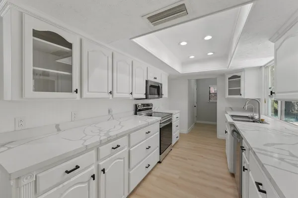a kitchen with stainless steel appliances granite countertop a sink stove and refrigerator