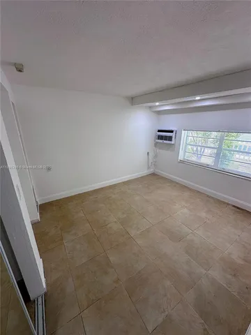 a view of an empty room and a window