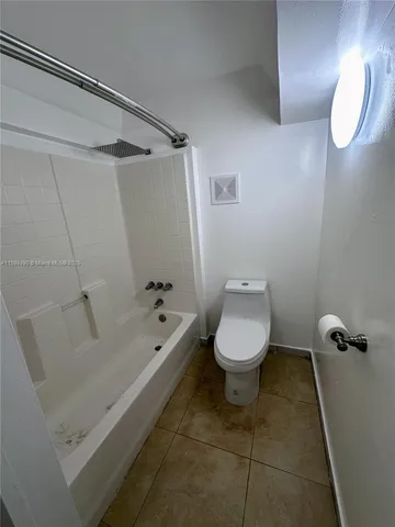 a bathroom with a toilet and a bathtub