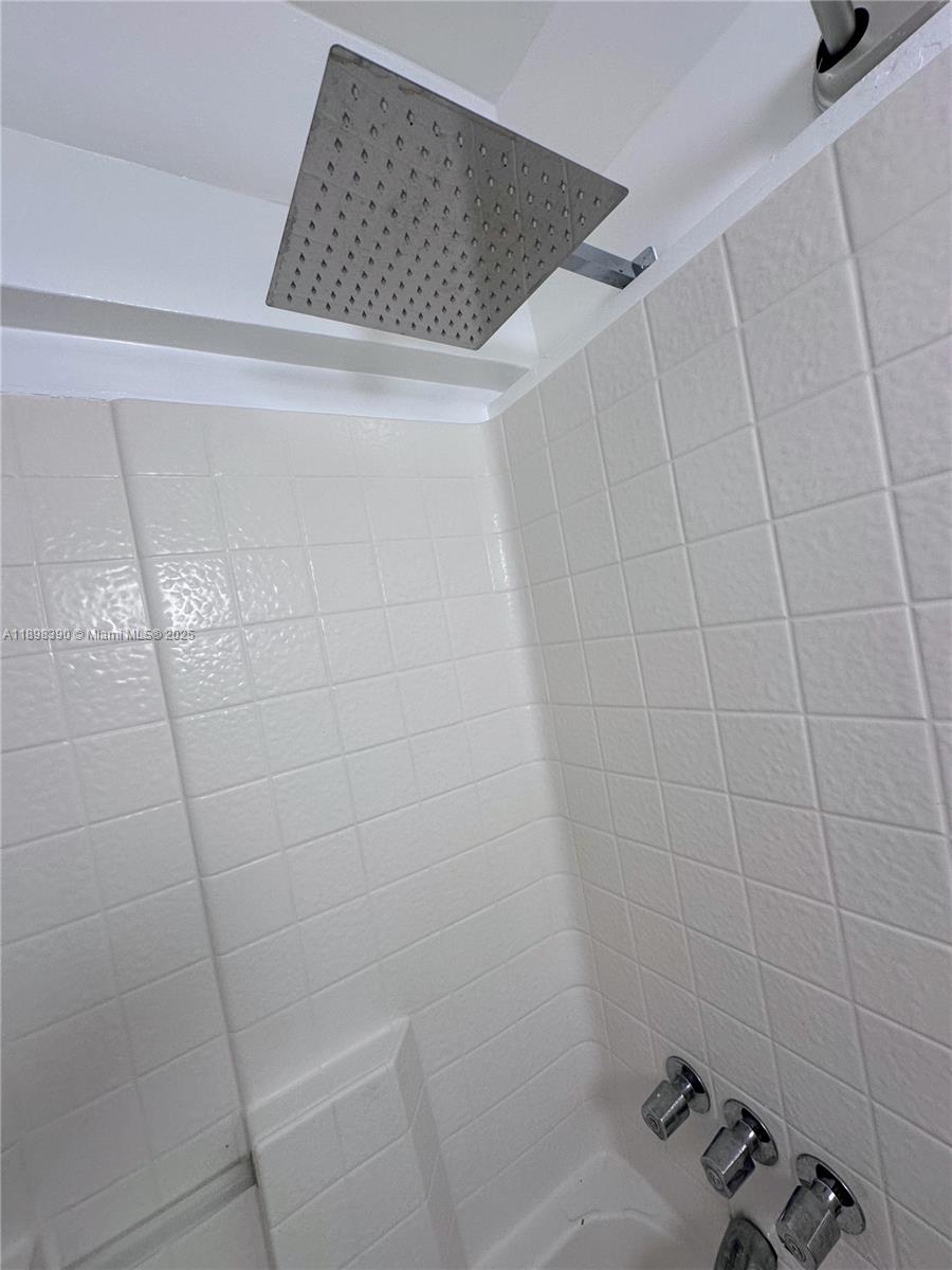 9064 Collins Avenue, Unit C19 Surfside, FL 33154 - Photo 16 of 17 a bathroom with a bathtub