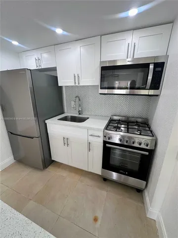 a kitchen with a stove and a microwave