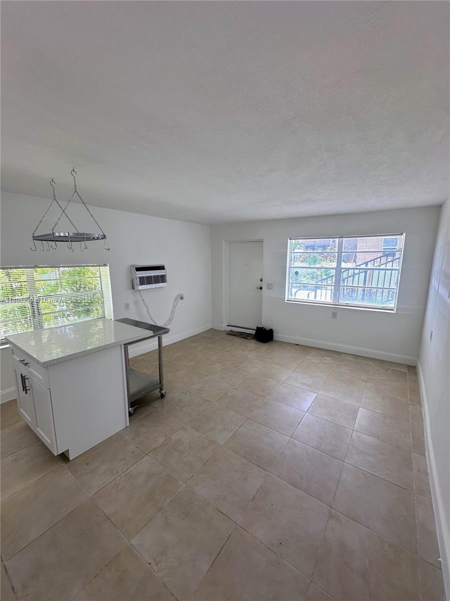 9064 Collins Avenue, Unit C19 Surfside, FL 33154 - Photo 9 of 17 a view of an empty room with a window