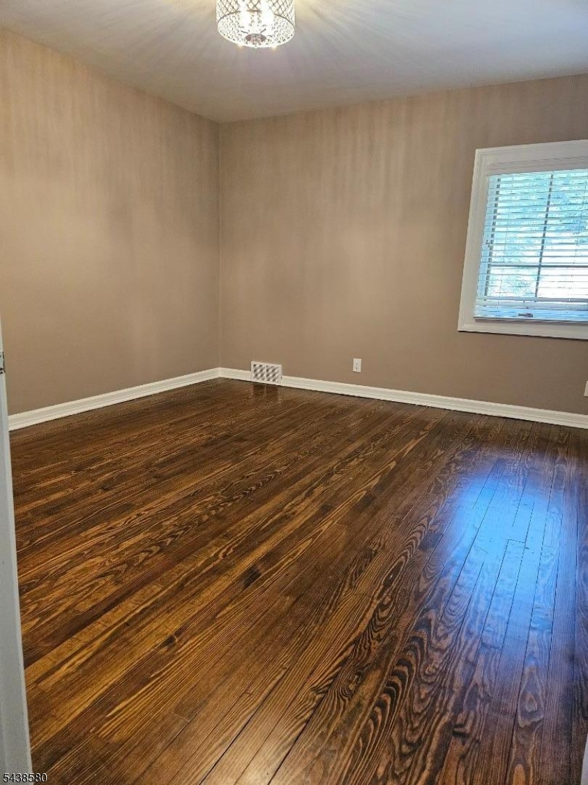 218 Devon Road Essex Fells, NJ 07021 - Photo 16 of 24 a view of an empty room with wooden floor and a window