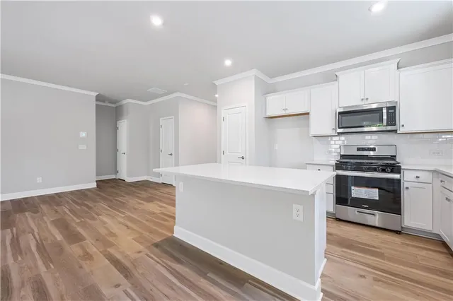 a kitchen with stainless steel appliances a refrigerator sink and stove