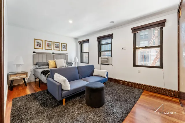 a bedroom with a large bed and a couch