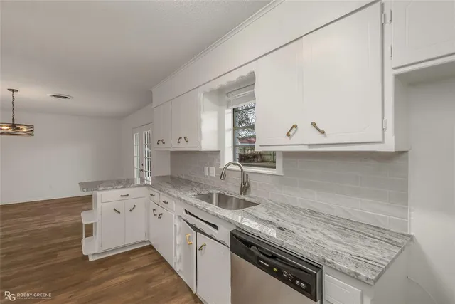 a kitchen with a sink stove and cabinets