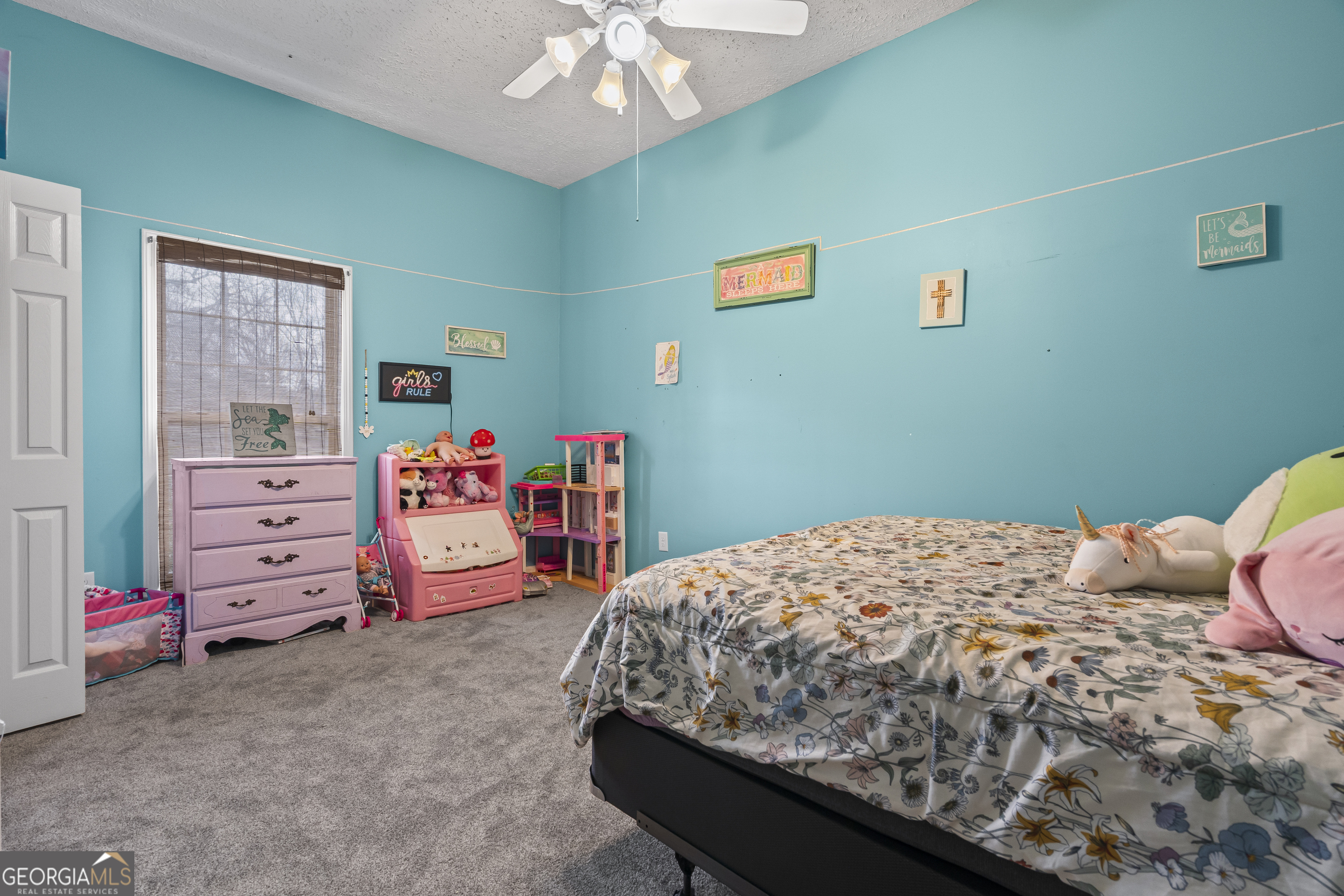 568 Hunt Road Carnesville, GA 30521 - Photo 45 of 106 a bedroom with a bed and a chandelier