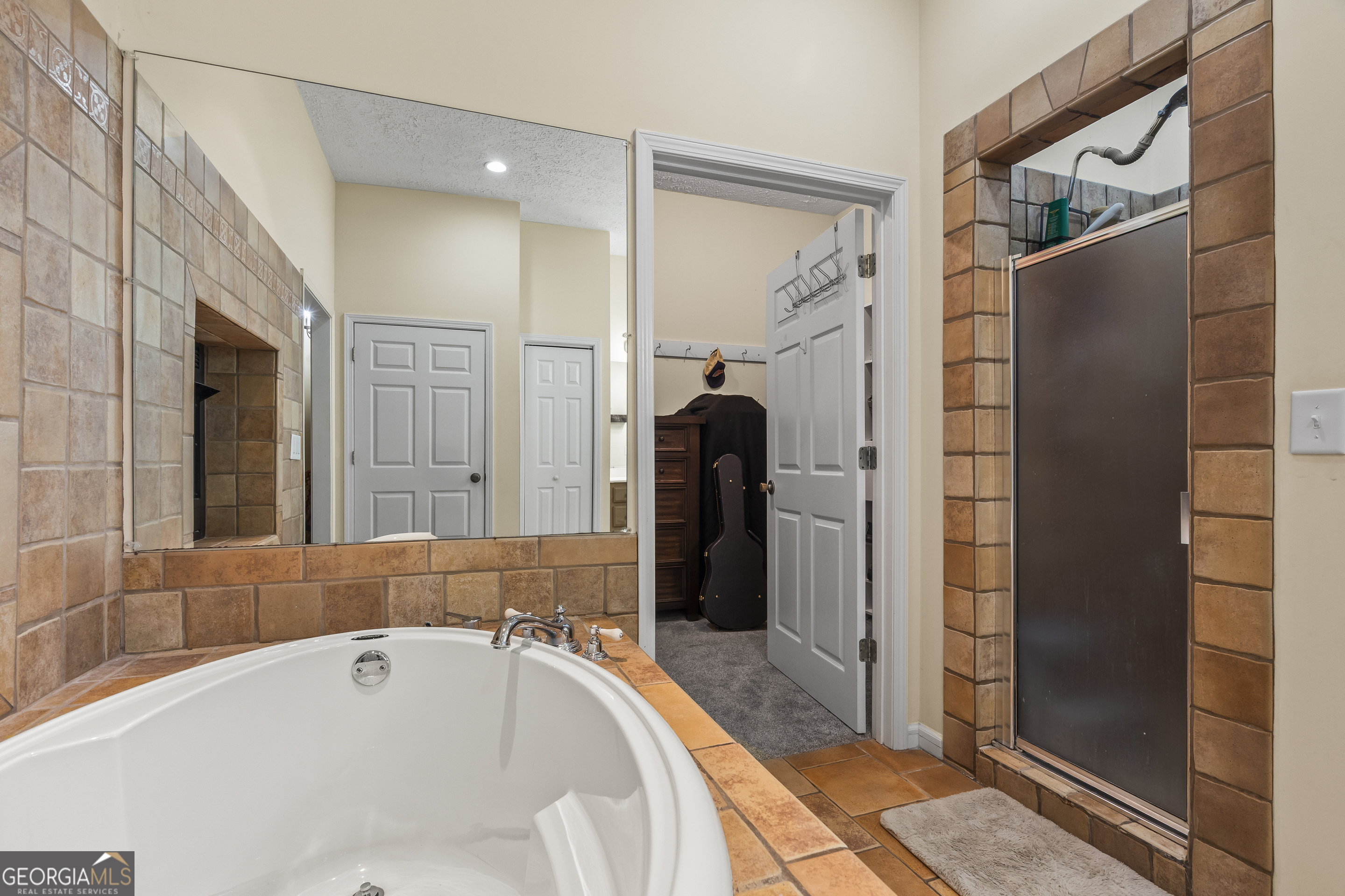 568 Hunt Road Carnesville, GA 30521 - Photo 57 of 106 a bathroom with a tub a mirror and shower