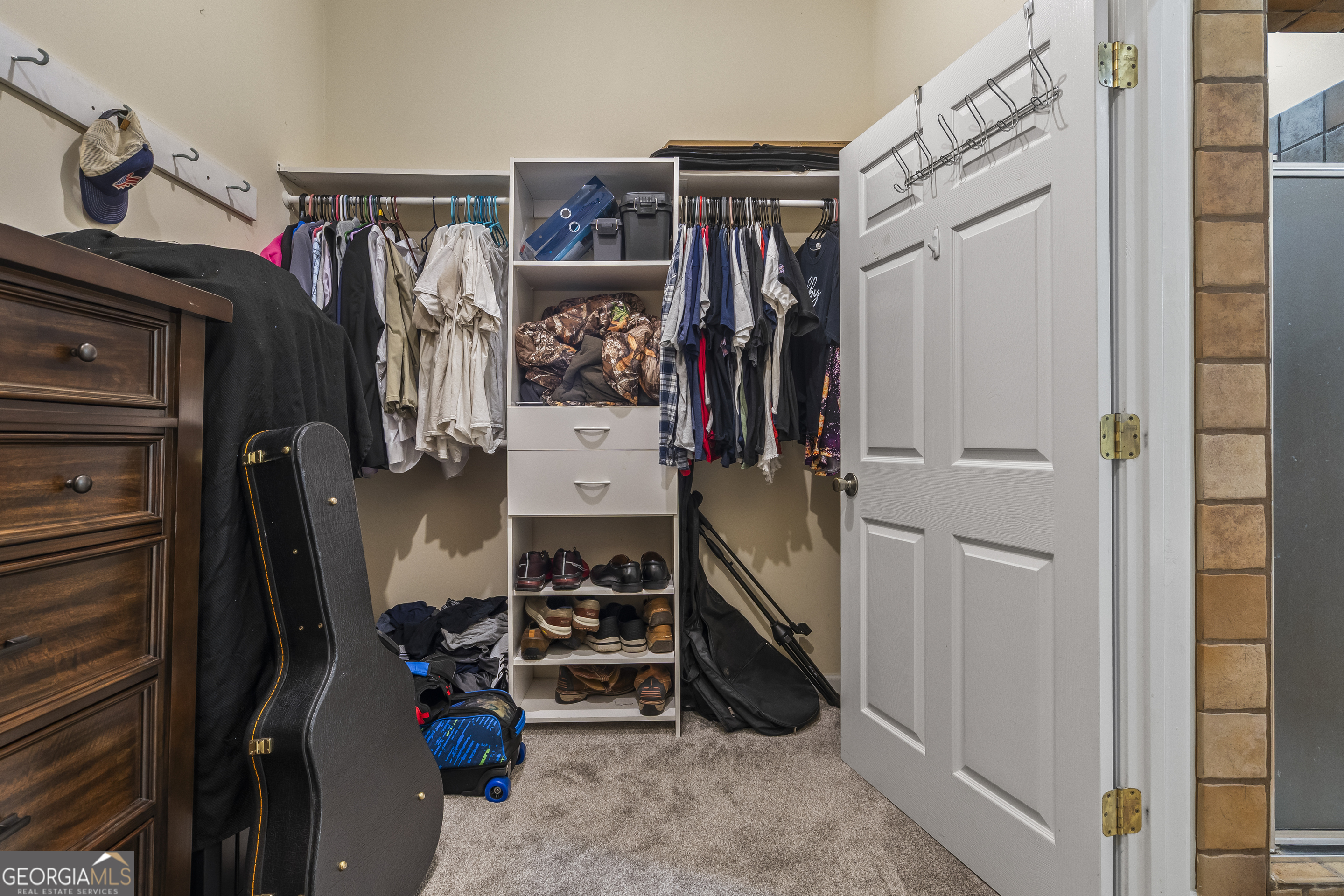568 Hunt Road Carnesville, GA 30521 - Photo 60 of 106 a view of walk in closet with clothes and shoes