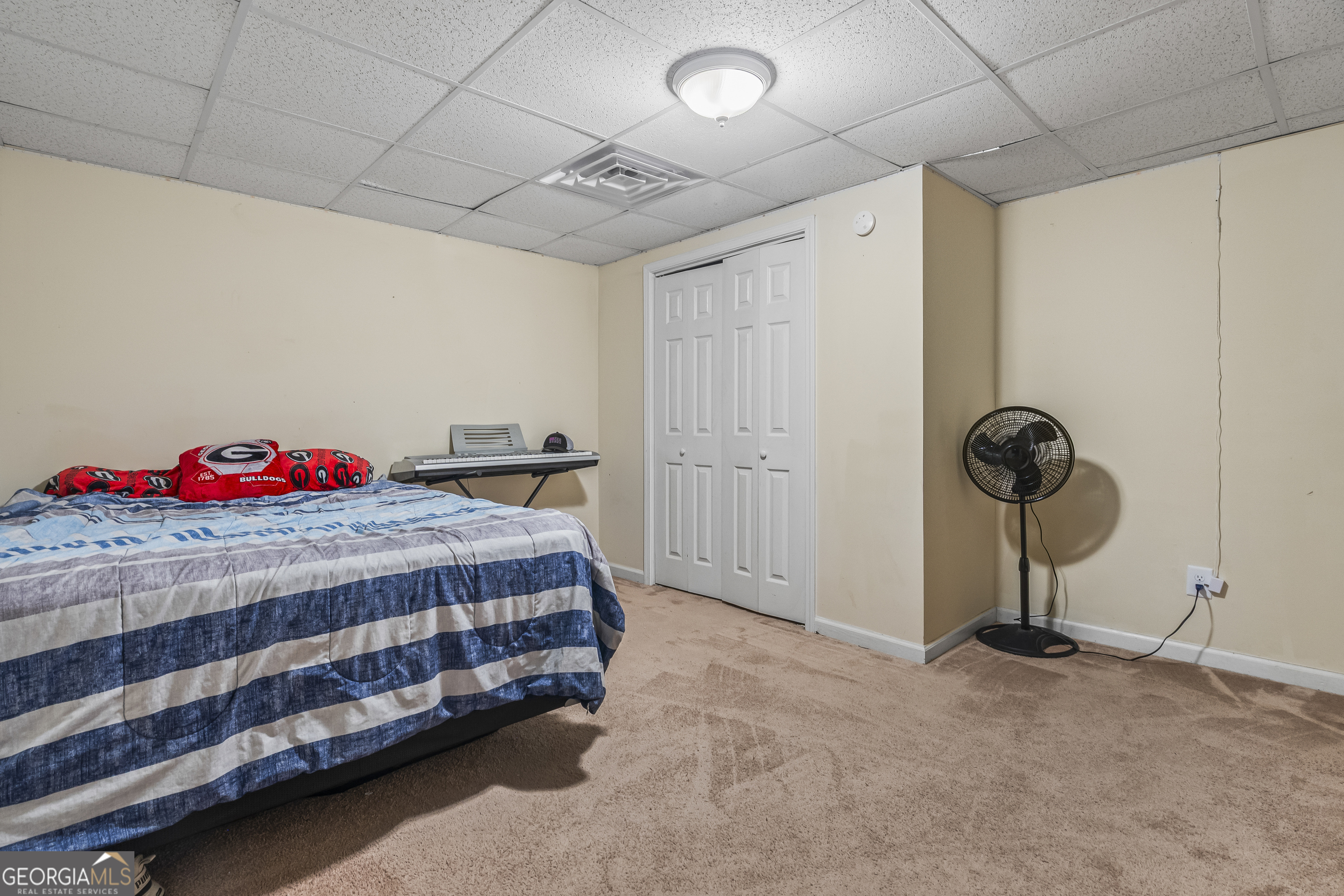 568 Hunt Road Carnesville, GA 30521 - Photo 70 of 106 a bedroom with a bed and a chandelier