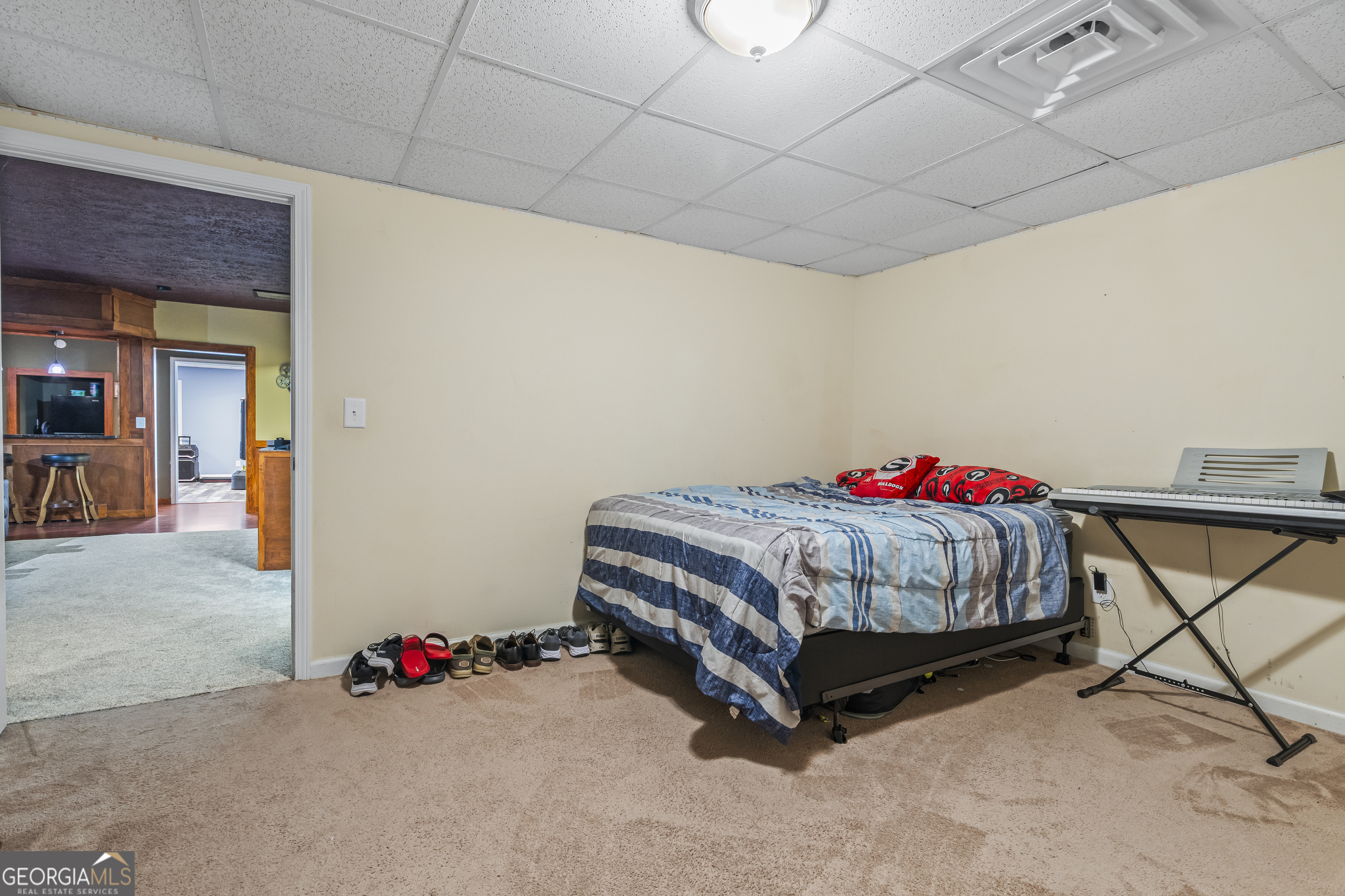 568 Hunt Road Carnesville, GA 30521 - Photo 72 of 106 a bedroom with a bed and a chandelier