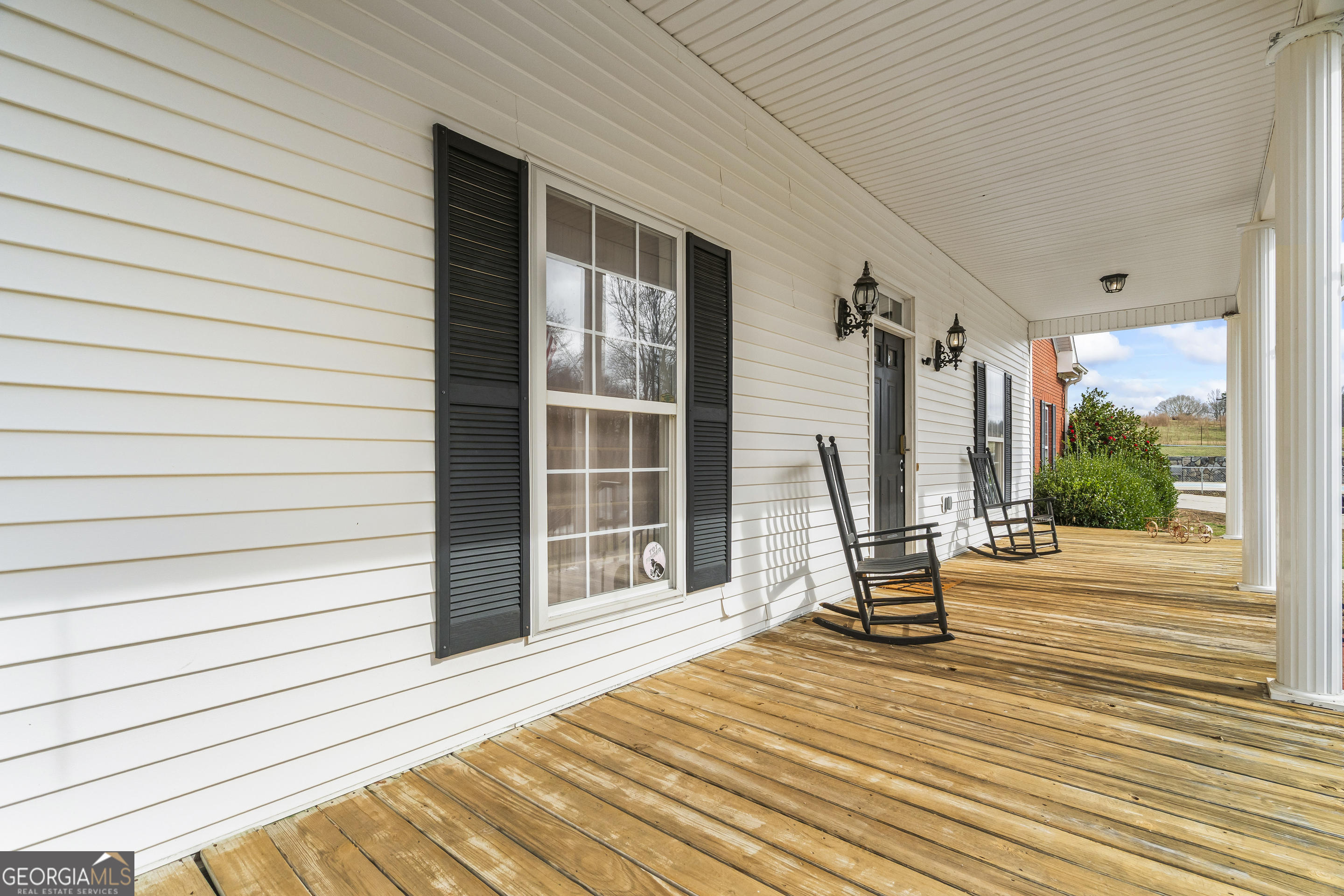 568 Hunt Road Carnesville, GA 30521 - Photo 9 of 106 a view of a patio with a table chairs and wooden floor