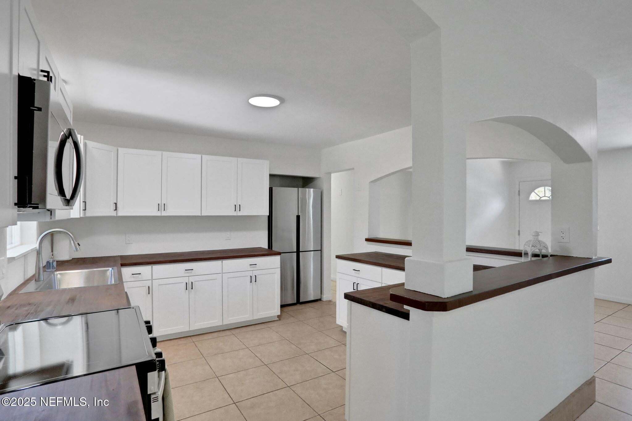 3849 Rogero Road Jacksonville, FL 32277 - Photo 12 of 47 a kitchen with stainless steel appliances granite countertop a sink and a refrigerator