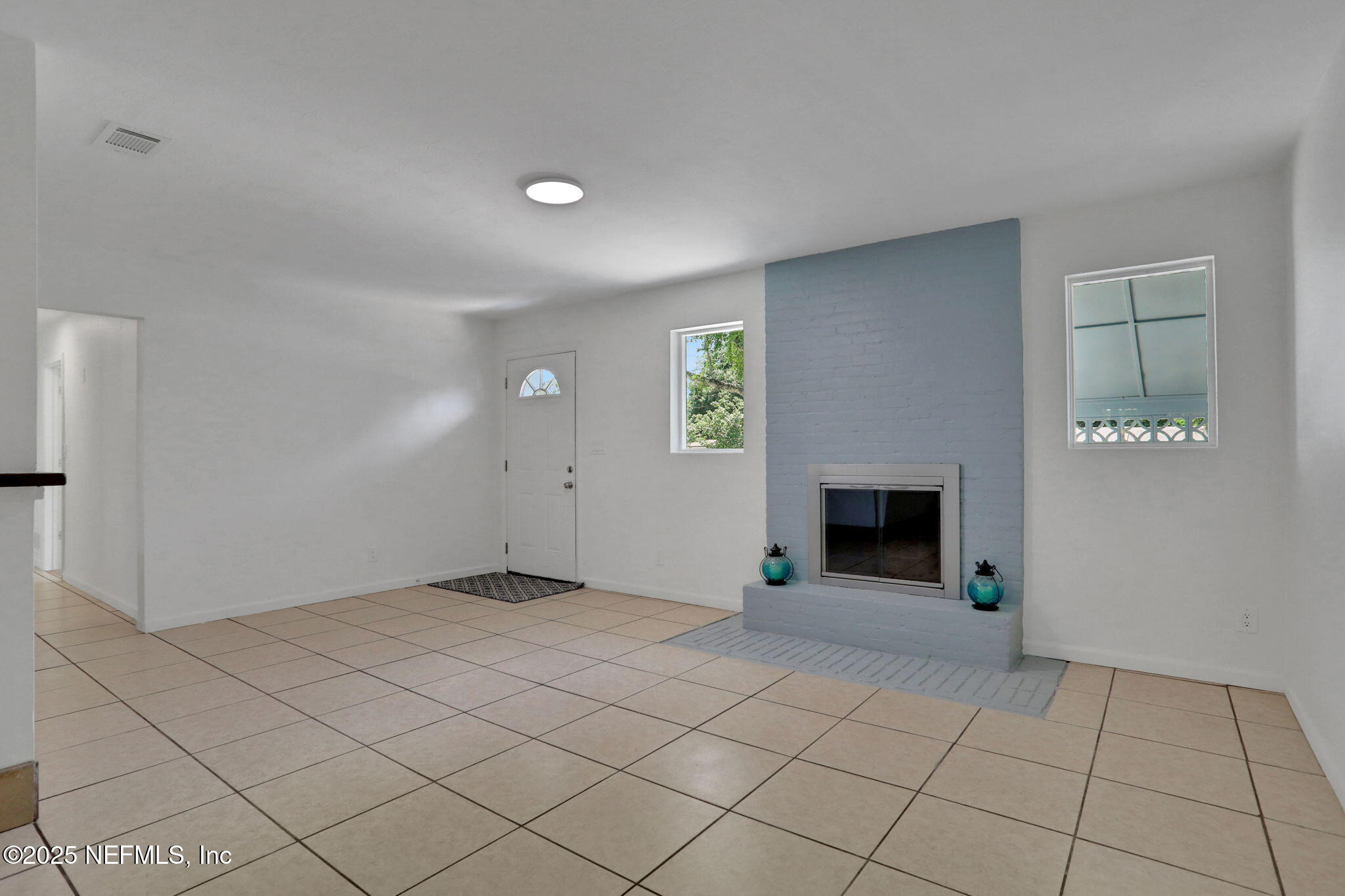 3849 Rogero Road Jacksonville, FL 32277 - Photo 8 of 47 an empty room with fireplace