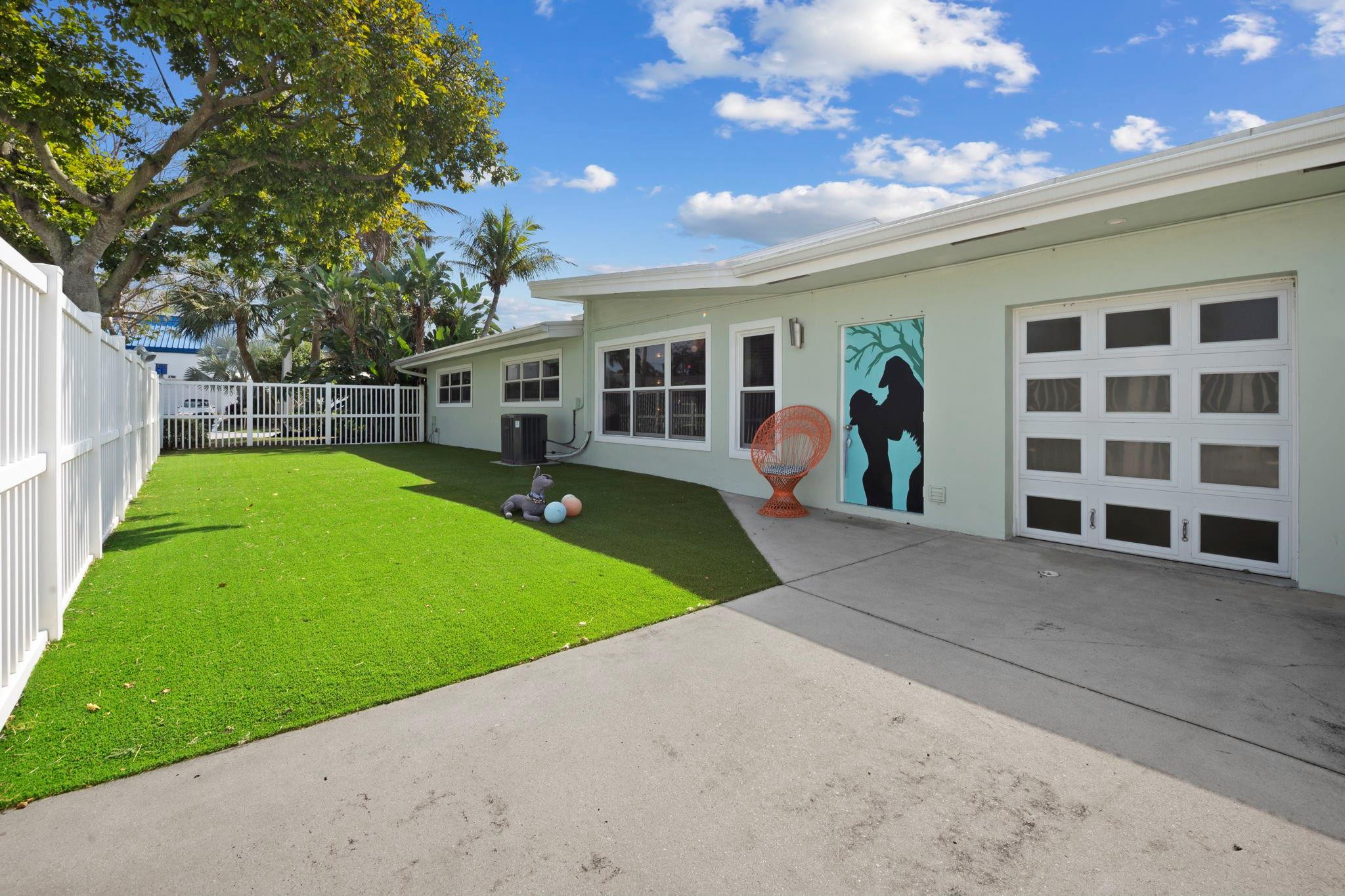2675 Northeast 24th Street Lighthouse Point, FL 33064 - Photo 27 of 48 a view of a house with a backyard and a tree