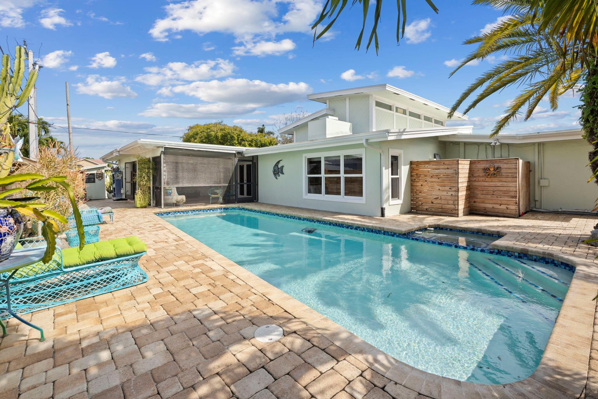 2675 Northeast 24th Street Lighthouse Point, FL 33064 - Photo 29 of 48 a view of a house with a swimming pool
