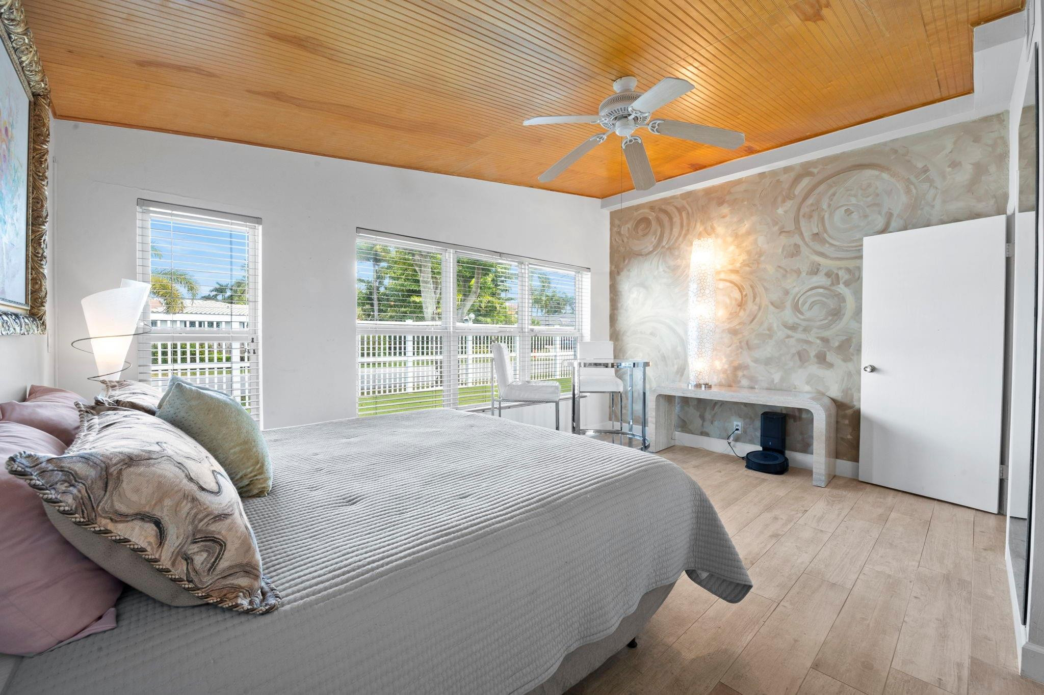 2675 Northeast 24th Street Lighthouse Point, FL 33064 - Photo 31 of 48 a bed sitting in a bedroom next to a window