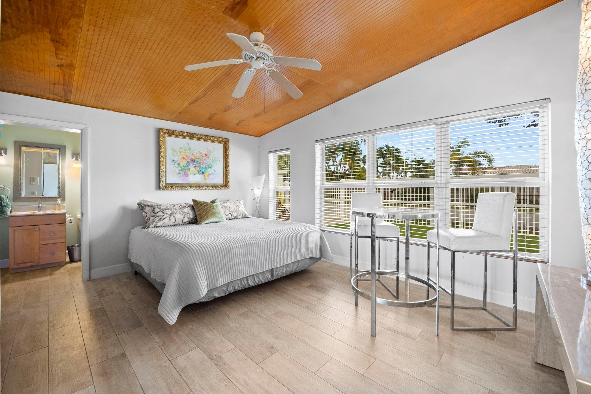 2675 Northeast 24th Street Lighthouse Point, FL 33064 - Photo 32 of 48 a bedroom with a large bed and a chandelier