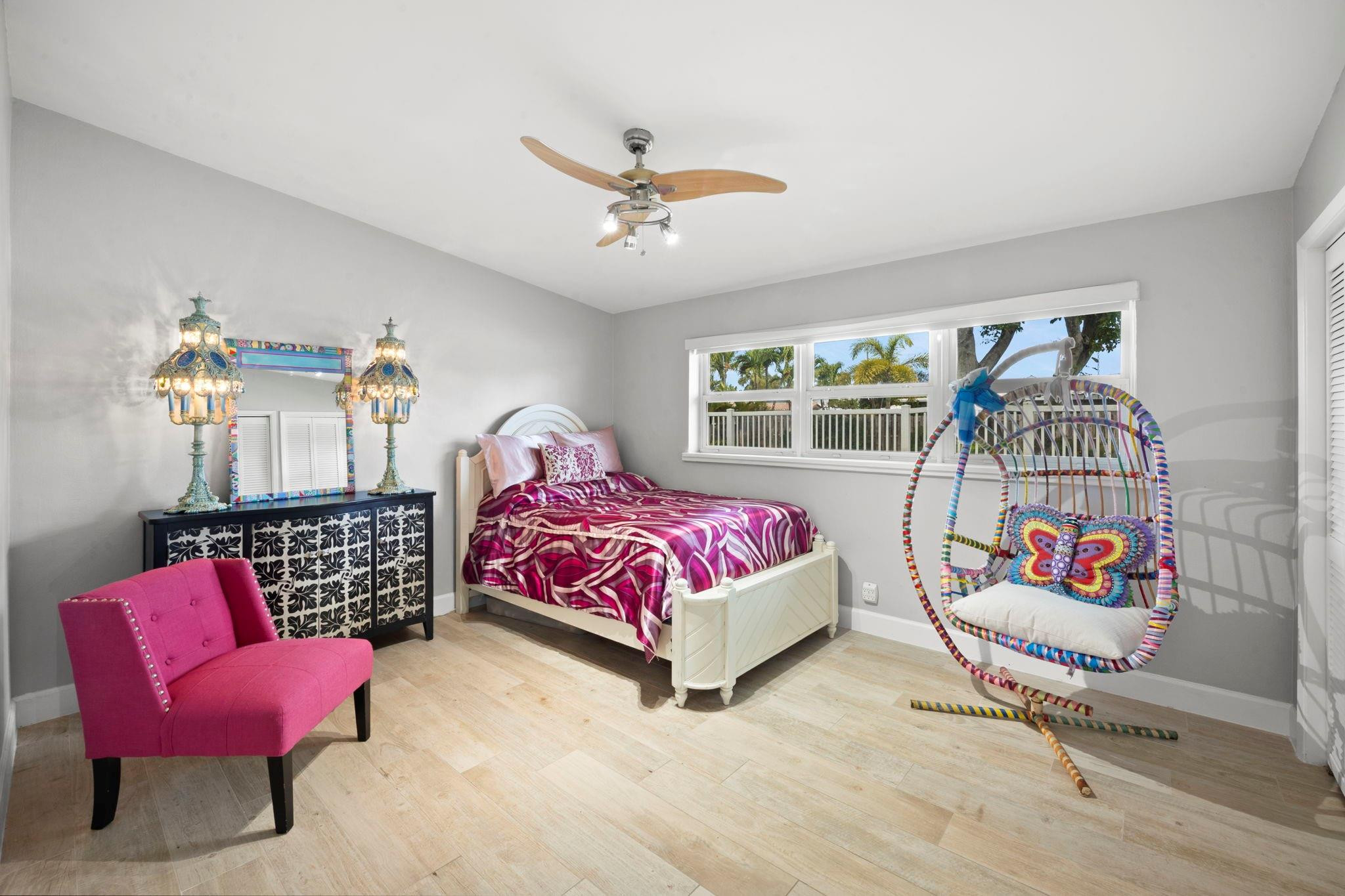 2675 Northeast 24th Street Lighthouse Point, FL 33064 - Photo 34 of 48 a bedroom with a bed and a chandelier