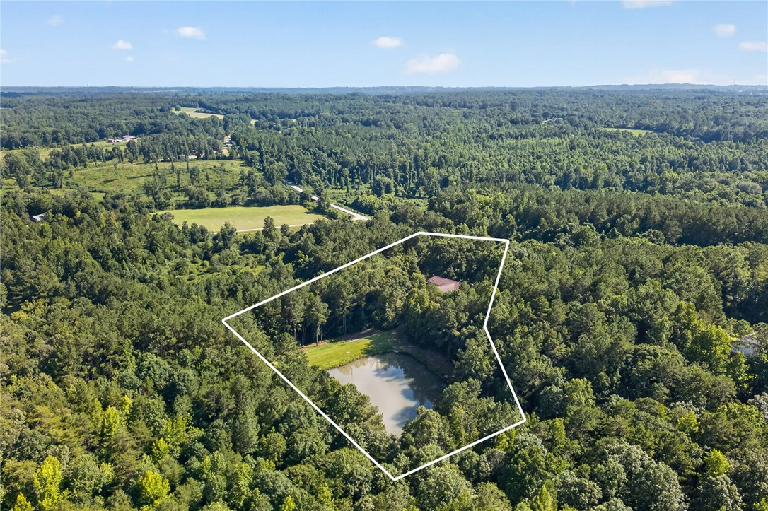 120 Coneross Knob Drive Seneca, SC 29678 - Photo 35 of 37 A private, wooded lot features a serene pond, offering an ideal escape.