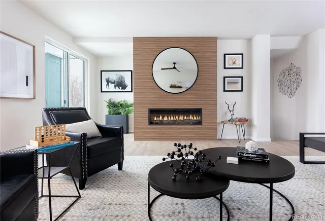 a living room with furniture a table and chair