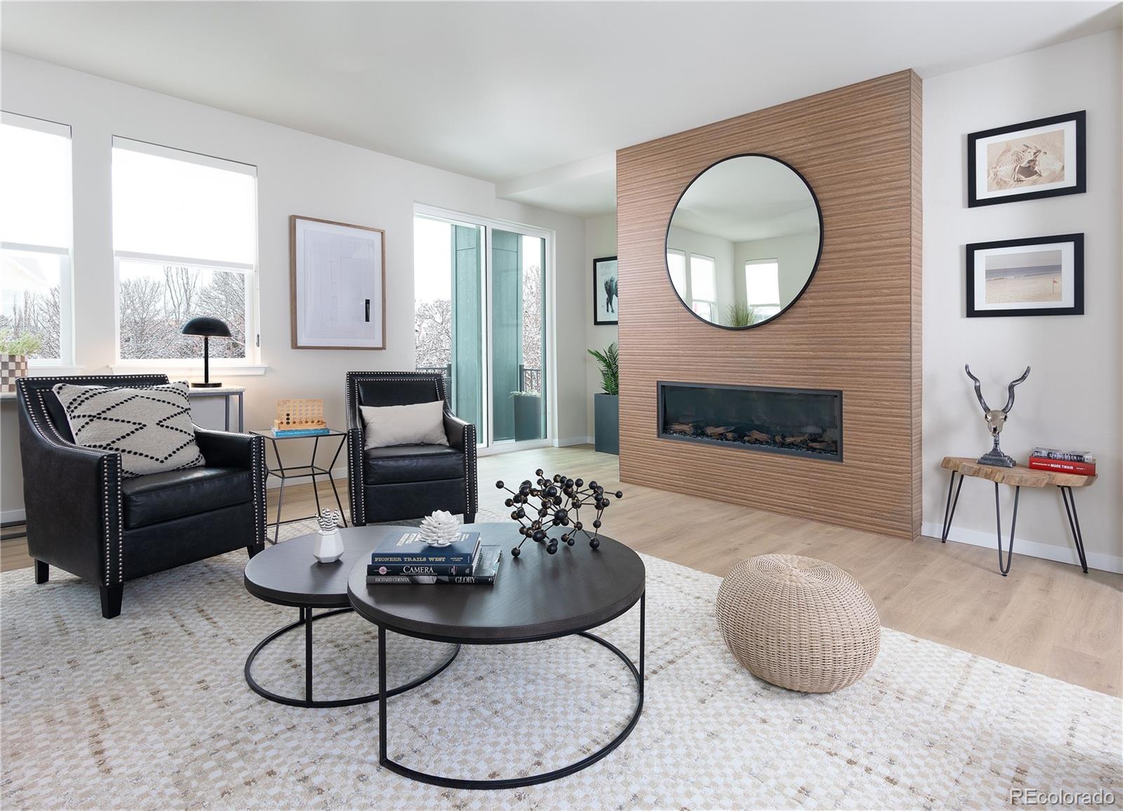 14472 Tranquil Court Morrison, CO 80465 - Photo 10 of 13 a living room with furniture a fireplace and a large mirror