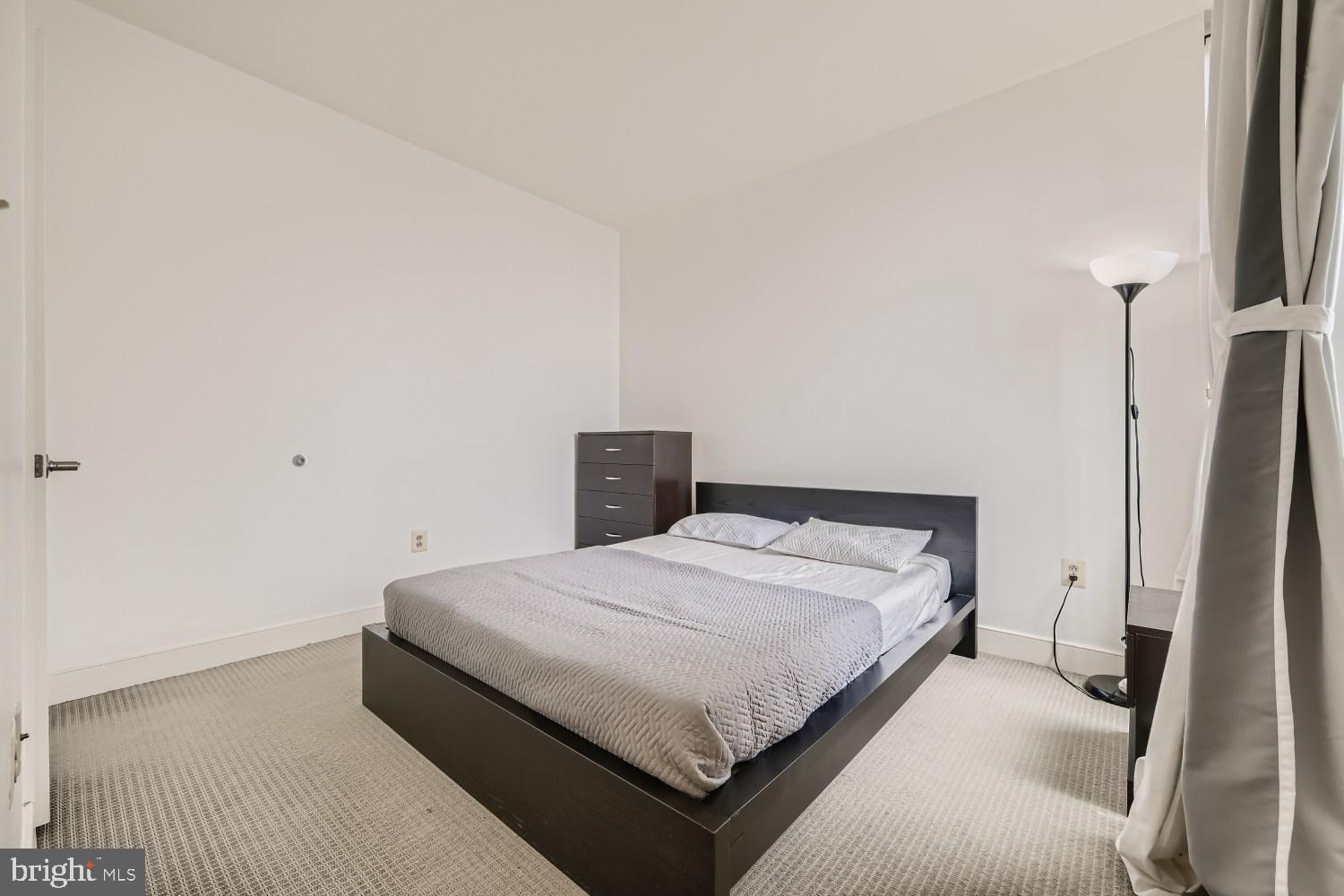 675 President Street, Unit 2107 Baltimore, MD 21202 - Photo 15 of 39 a bedroom with a bed and a flat screen tv