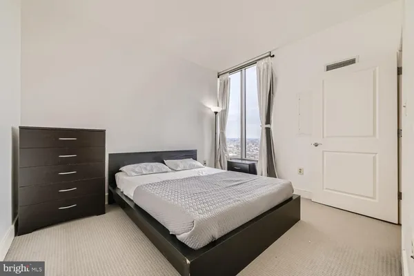 a bedroom with a bed and a dresser