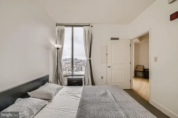a bedroom with a bed and a window