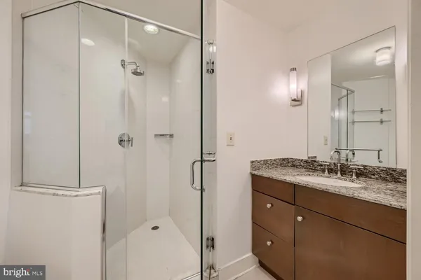a bathroom with a granite countertop sink mirror and double