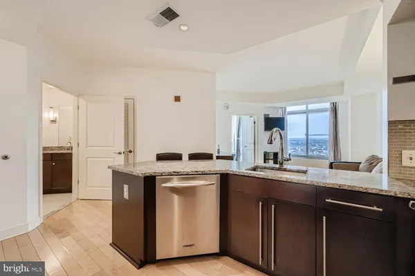 a kitchen with stainless steel appliances granite countertop a stove a sink dishwasher and a refrigerator