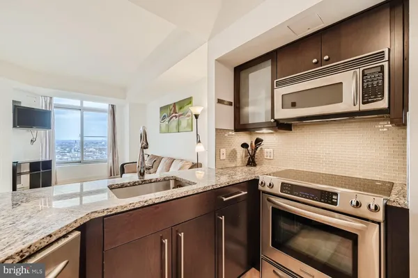 a kitchen with a sink stove and microwave