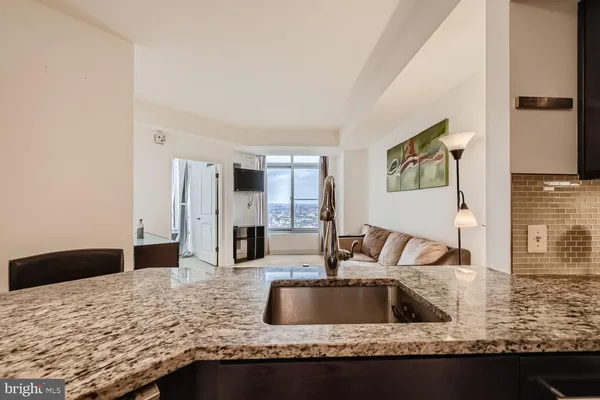 a kitchen with granite countertop a granite counter tops and a view of living room