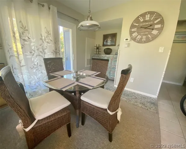 a dining room with furniture and window