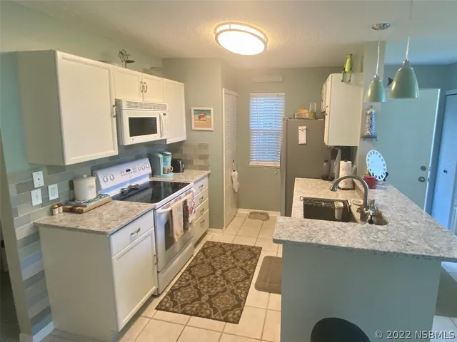 a kitchen with a sink stove and microwave