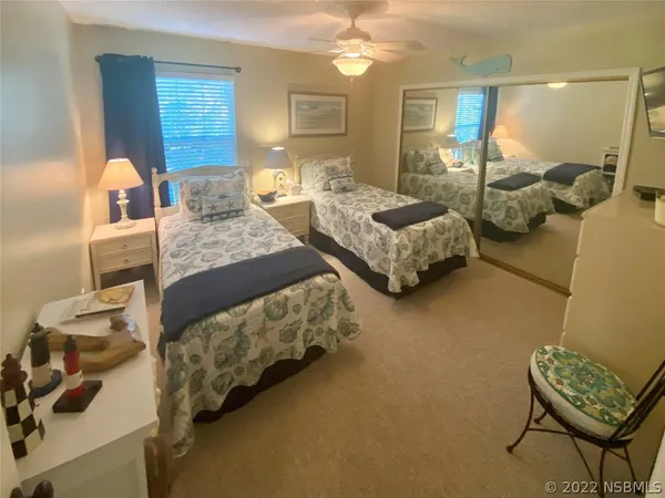 a bedroom with furniture and a mirror