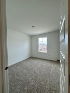 2136 Bodega Road, Unit 2136 Oswego, IL 60543 - Photo 17 of 19 an empty room with windows