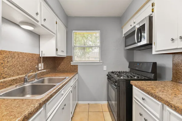 a kitchen that has a sink and a stove
