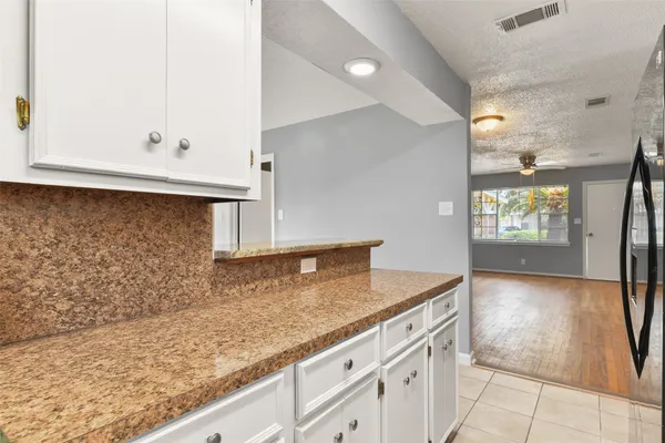 a kitchen with granite countertop a sink and a white stove