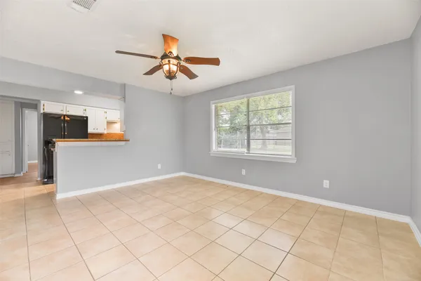a view of a kitchen with furniture and a ceiling fan