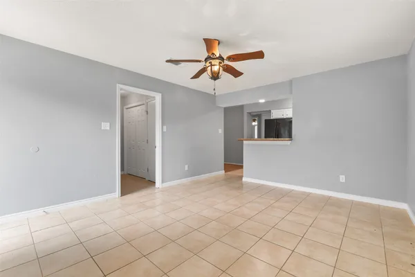 a view of a livingroom with a ceiling fan and window