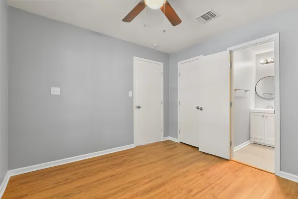 a view of empty room with wooden floor